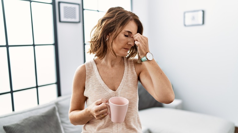 Woman feeling sick while drinking coffee