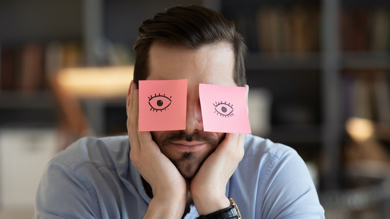 Man feeling tired while at work