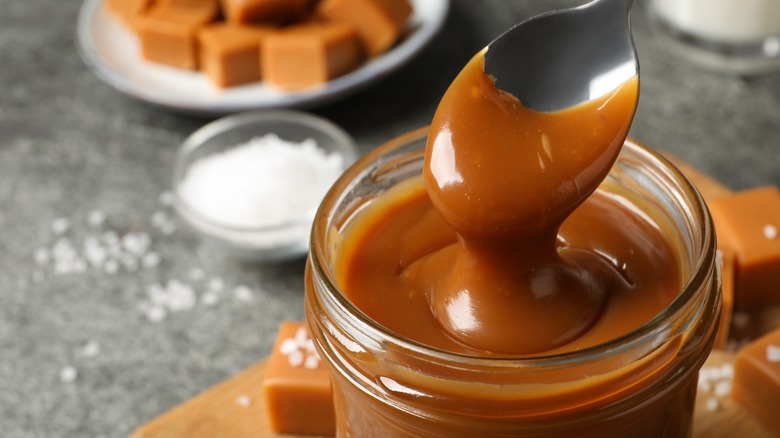 smooth and creamy salted caramel sauce dipped with spoon