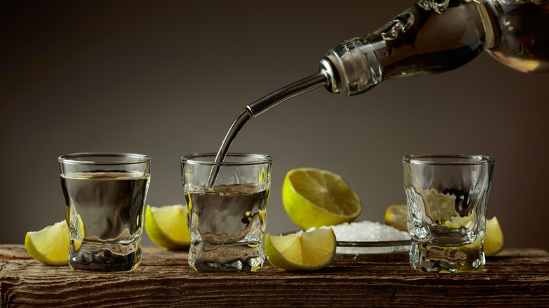 Tequila being poured into shot glass