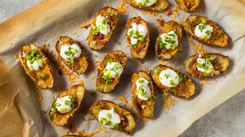 loaded potato skins on parchment paper