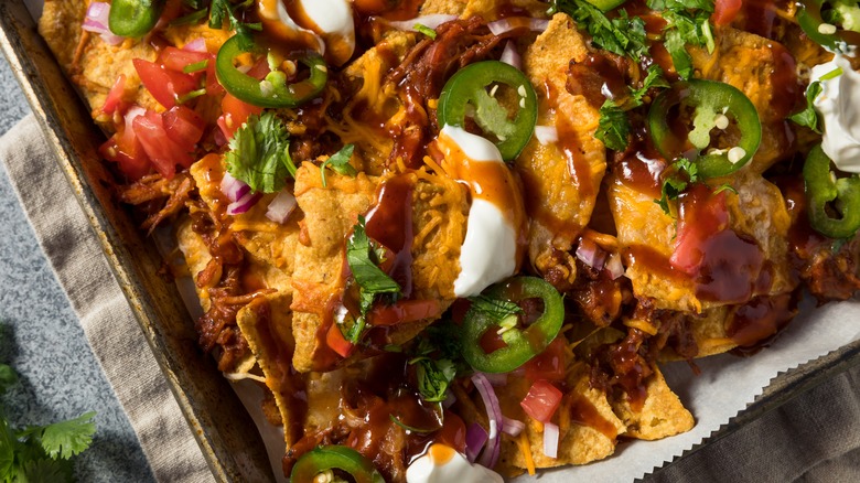pulled pork nachos with cheese and jalapeños