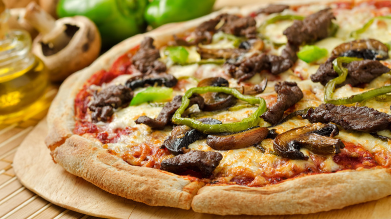 Steak pizza with mushrooms and peppers