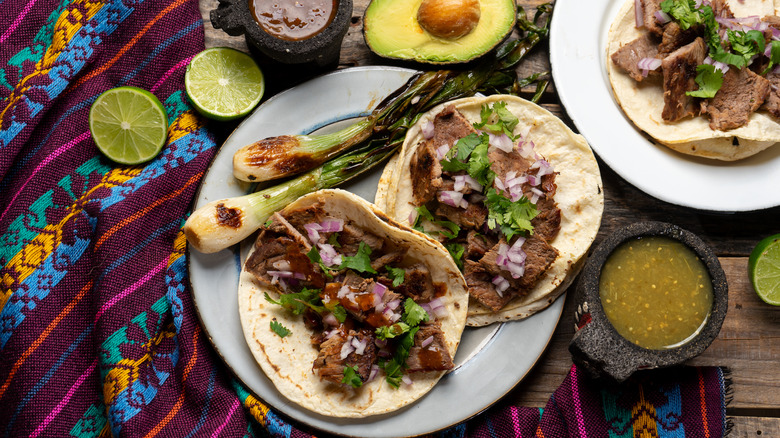 Steak tacos with lime and salsa