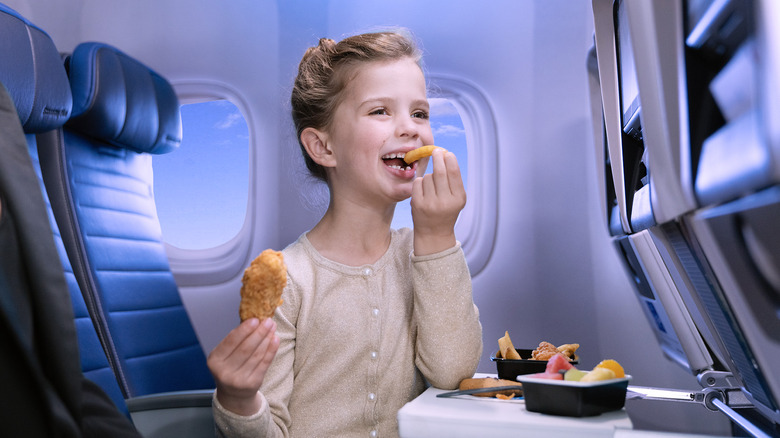 happy child eating airline food