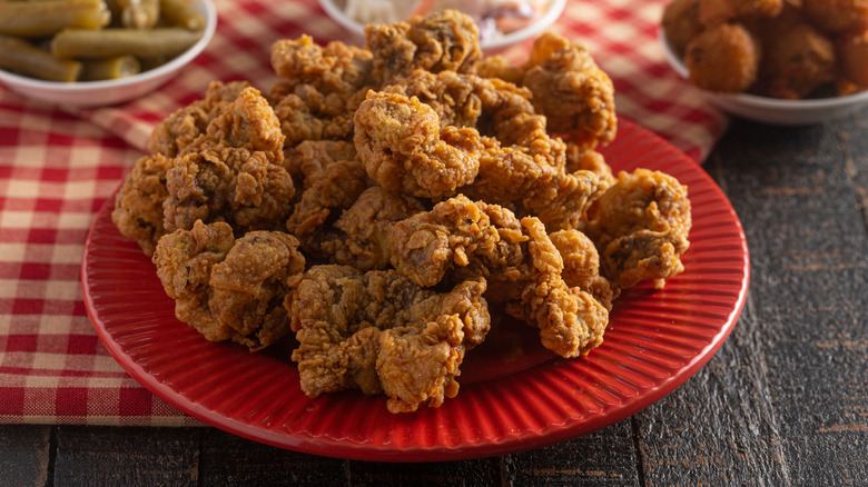 Fried gizzards on red plate