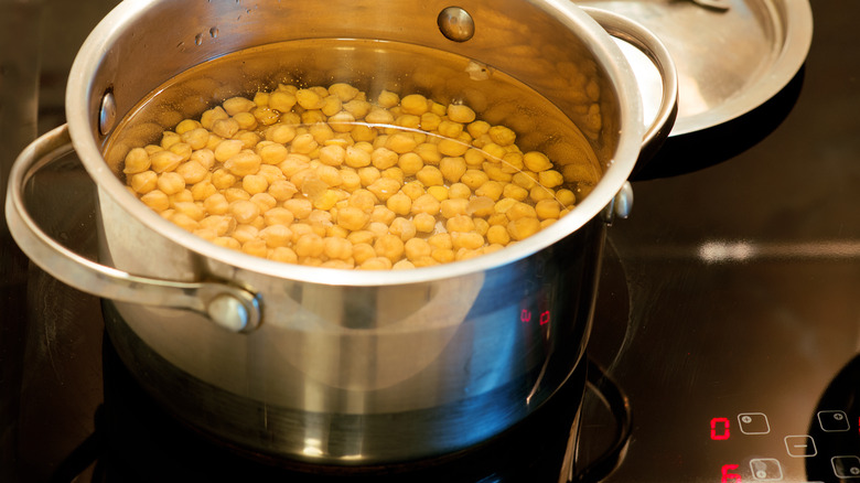 Chickpeas in water in a pot on a stove