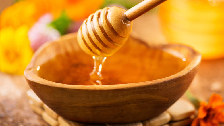 dipper dripping honey into bowl