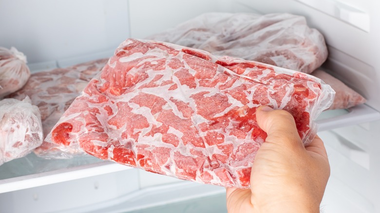 Removing vacuum packed frozen ground beef