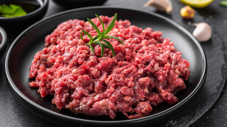 Fresh ground beef on a black plate