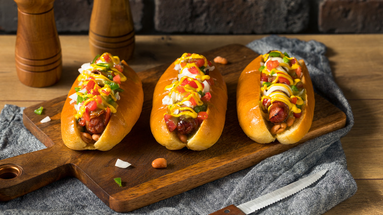 Sonoran hot dogs on cutting board