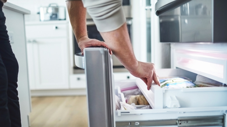 Person rummaging through freezer