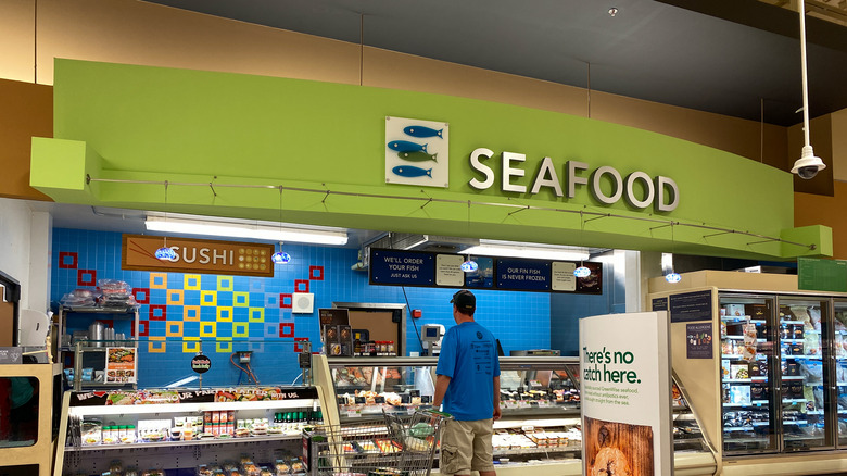 Person standing at seafood counter