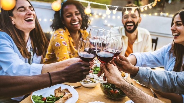 group of friends toasting wine