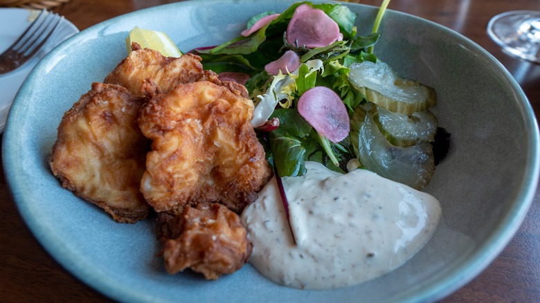 Cooked cod tongues on plate