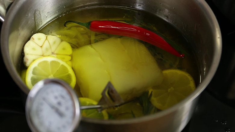 Confit cod cooking