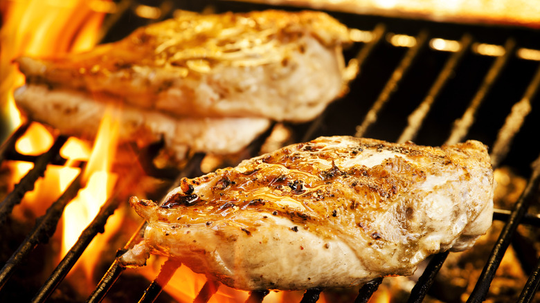 chicken filets on flaming grill