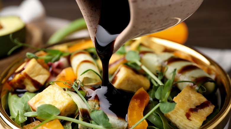 pouring vinegar onto salad