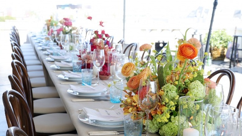 A dinner table with flowers