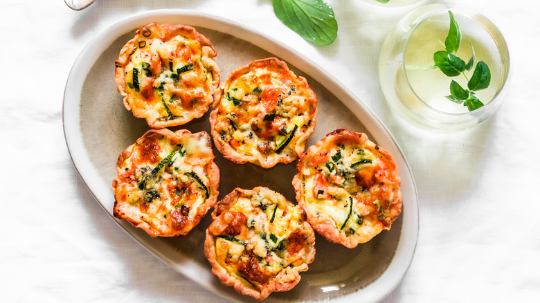 Mini salmon quiche and aqua vitae