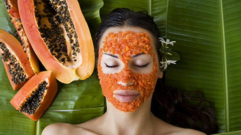 woman with papaya puree on face