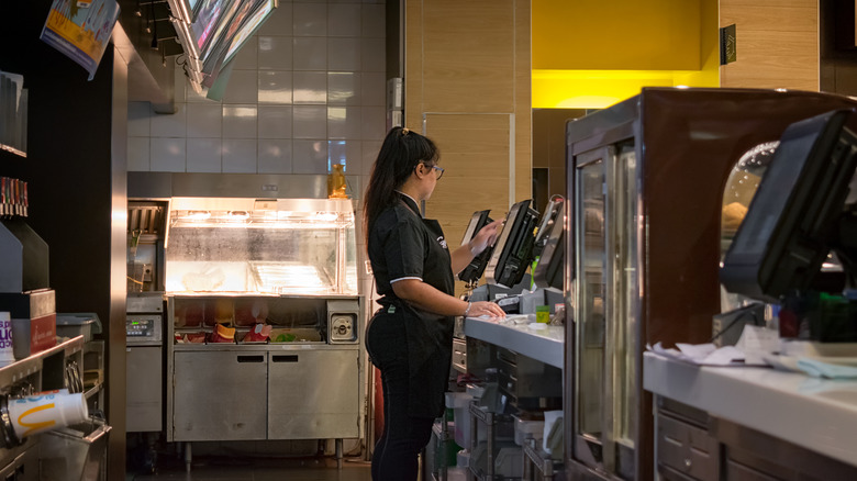 A McDonald's employee at POS system