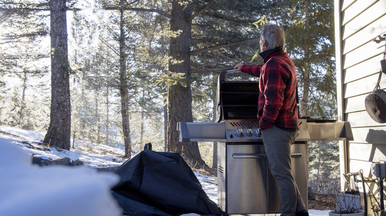 Man at grill in snow