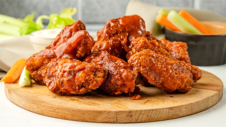 Hot wings on wooden plate 