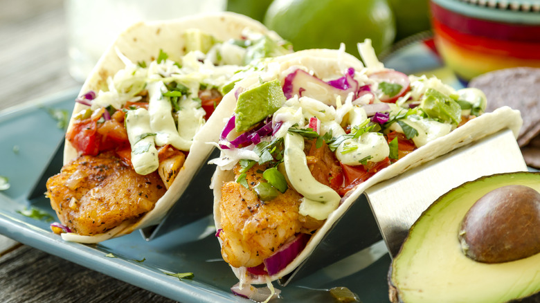 Two fish tacos with avocado crema