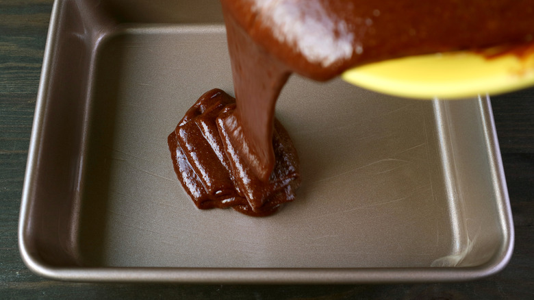 pouring batter into cake pan