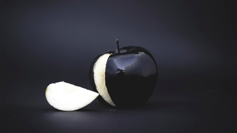 Black apple with missing slice 