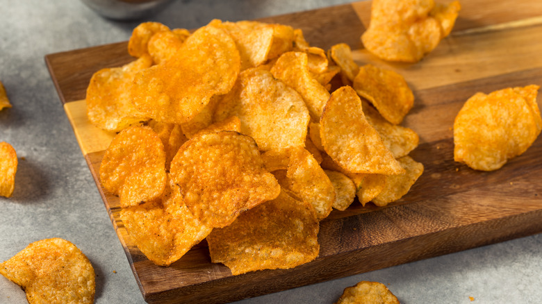 Seasoned chips arranged on a wooden cutting board