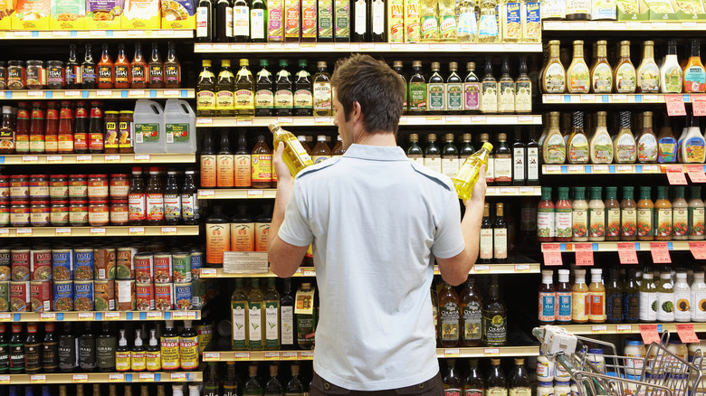 Man shopping for oil