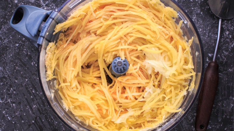 Grated potatoes in a food processor