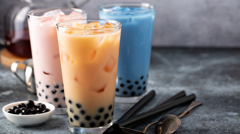 Three glasses of colorful boba tea