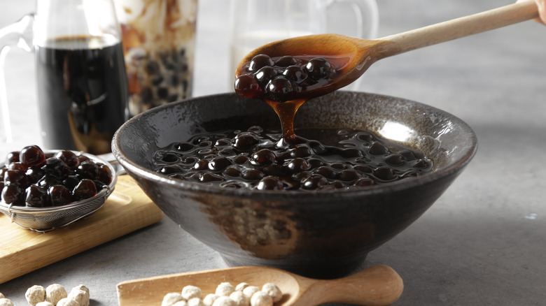 spooning tapioca pearls from a bowl 