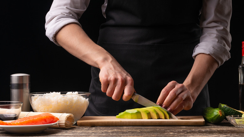 Chef cutting an avocado 