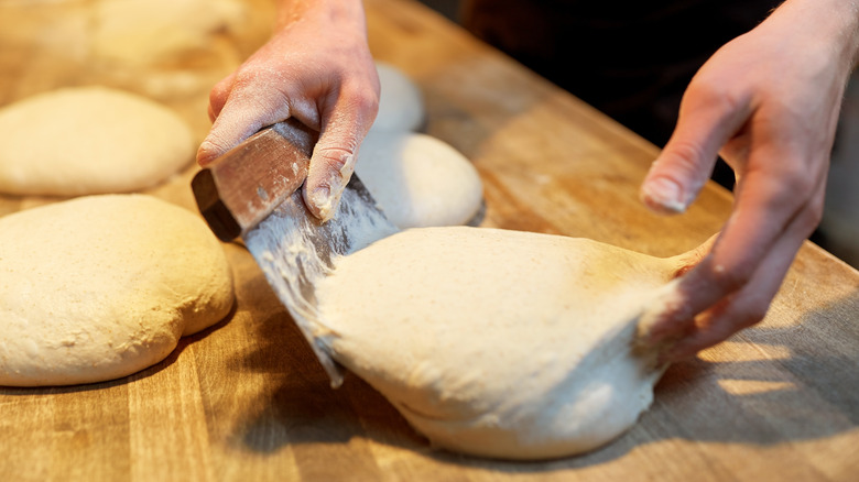 Moving dough with bench scraper