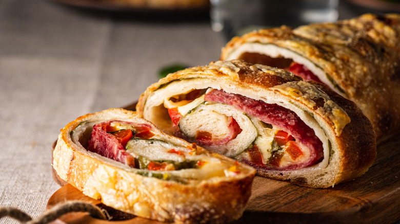 Stromboli sliced on wooden board