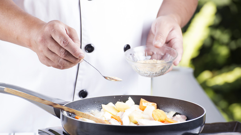 adding chicken powder to pan