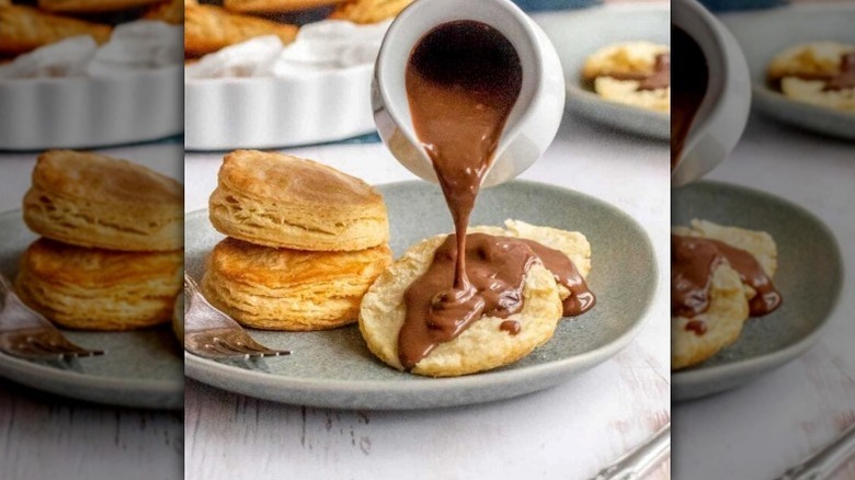 Chocolate gravy being poured over biscuits