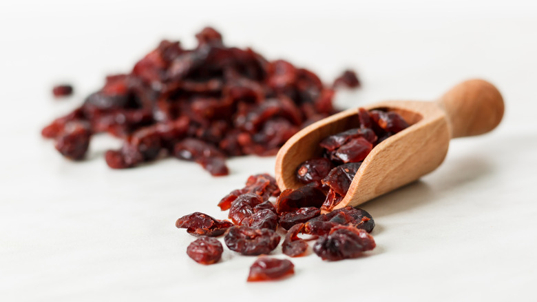 Wooden scoop full of dried lingonberries