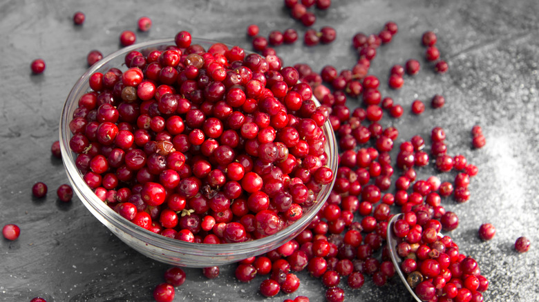 Overflowing glass bowl of freshly picked cranberries