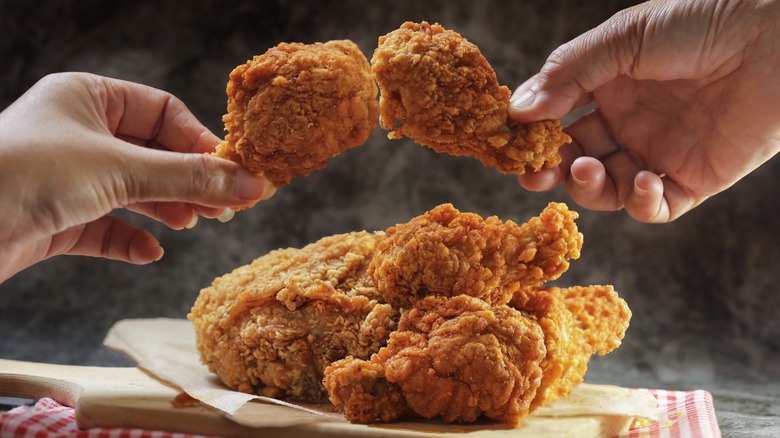 toasting with fried chicken drumsticks