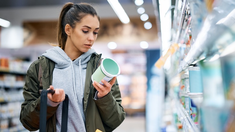 woman reading dairy product label