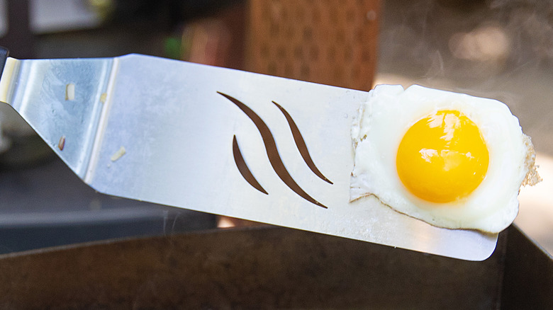 Spatula flipping an egg