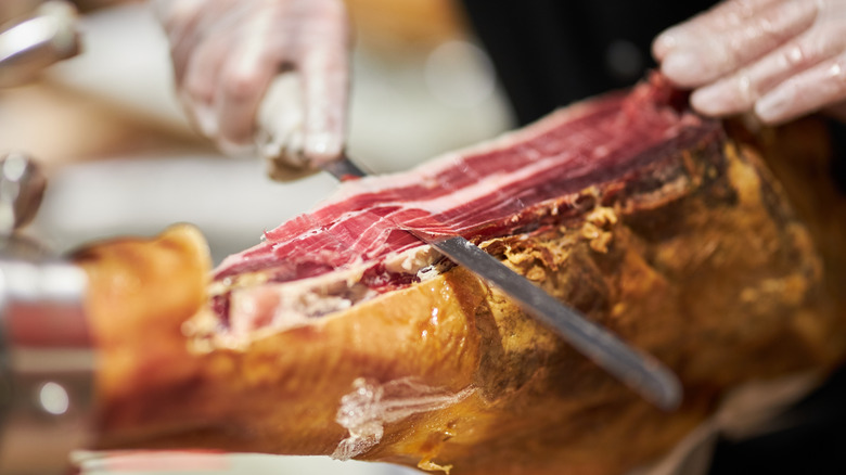 Hand carving cured ham