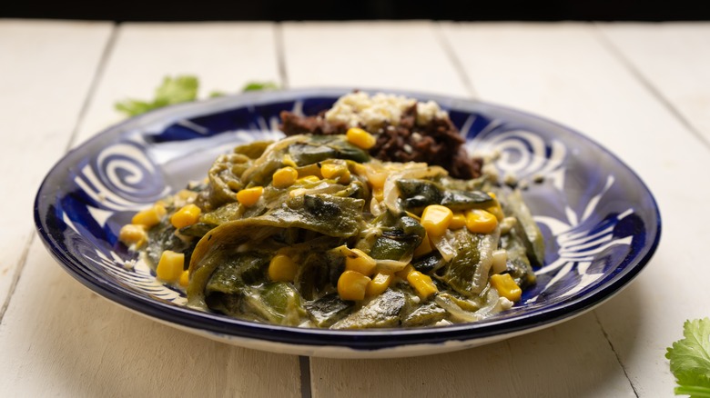 A dish of roasted poblano peppers with cream sauce and corn