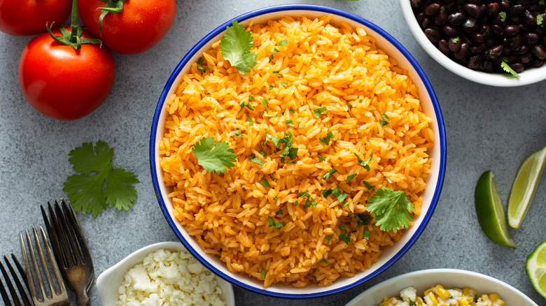 Mexican rice with fresh cilantro, beans, cotija, and lime