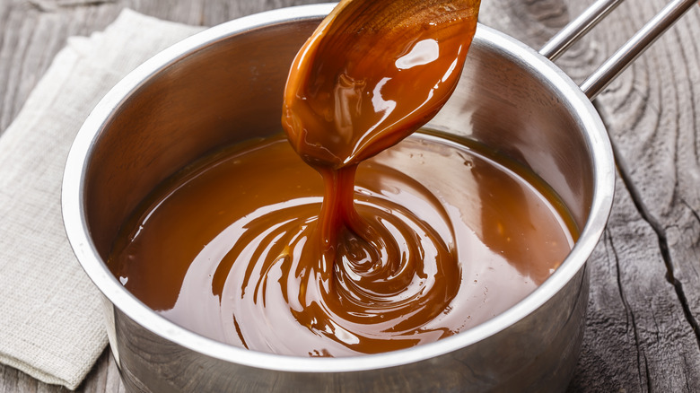 Spoon stirring liquid caramel